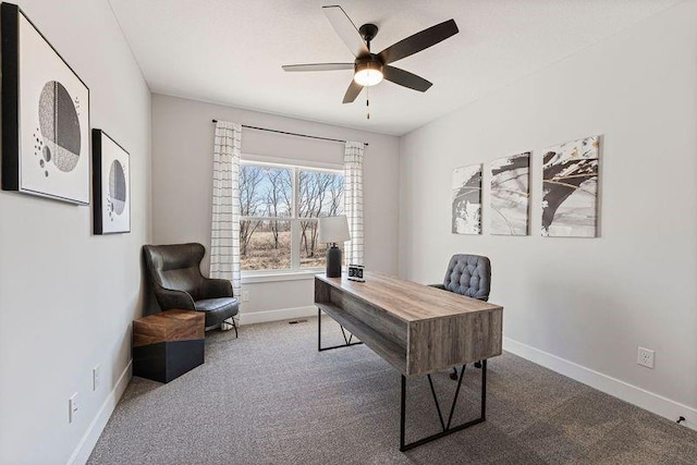 home office featuring carpet flooring, baseboards, and a ceiling fan