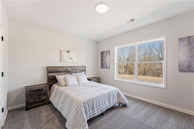 bedroom featuring baseboards and carpet