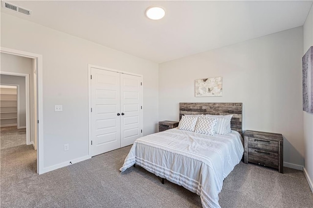bedroom with carpet floors, baseboards, and a closet