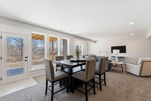 carpeted dining space featuring recessed lighting