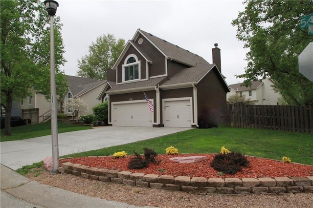 view of front facade featuring fence, a front yard, a chimney, concrete driveway, and an attached garage