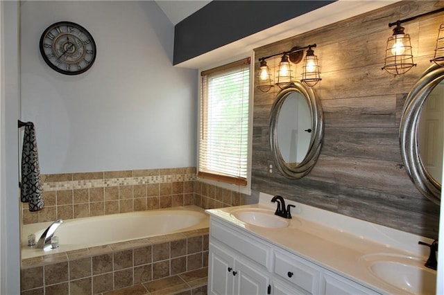 full bath featuring a garden tub, a sink, tile patterned flooring, and double vanity