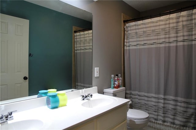 full bathroom featuring a sink, toilet, double vanity, and a shower with shower curtain