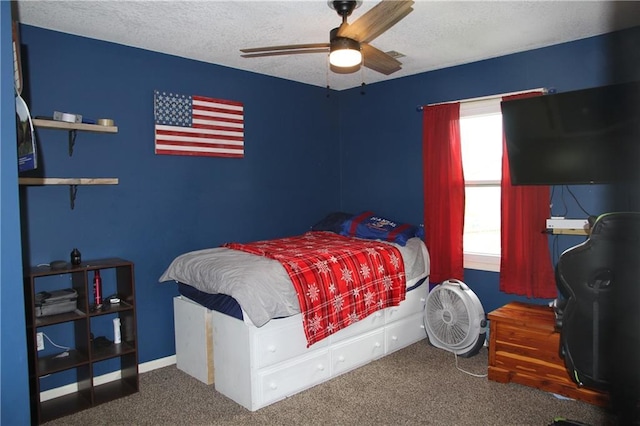 carpeted bedroom with ceiling fan and a textured ceiling