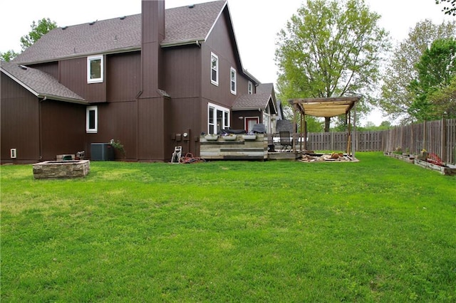 view of yard featuring a fenced backyard, a wooden deck, and central AC