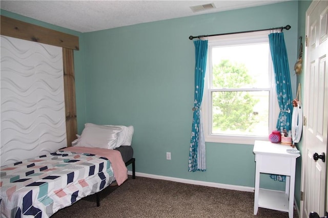 bedroom with carpet floors, baseboards, visible vents, and multiple windows