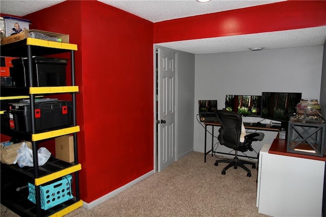 home office featuring baseboards, carpet, and a textured ceiling