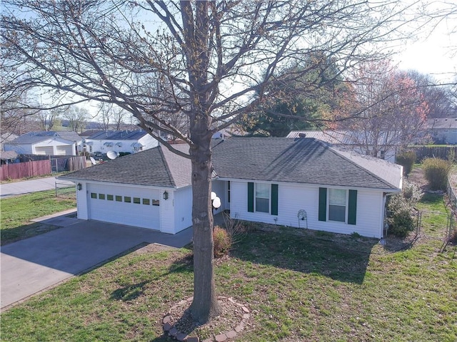 ranch-style house featuring concrete driveway, a front lawn, fence, and an attached garage