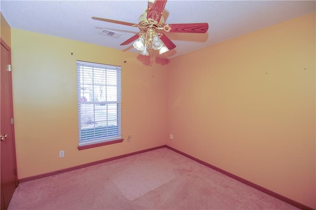 unfurnished room featuring visible vents, baseboards, a ceiling fan, a textured ceiling, and light colored carpet