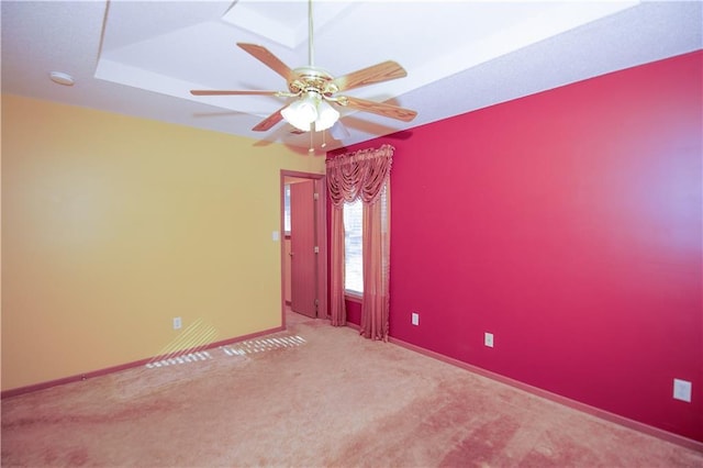 spare room with ceiling fan, baseboards, and carpet flooring