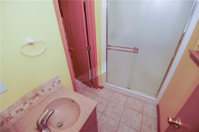 full bathroom featuring tile patterned floors, a stall shower, and vanity
