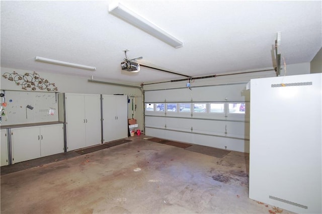 garage featuring a garage door opener and fridge