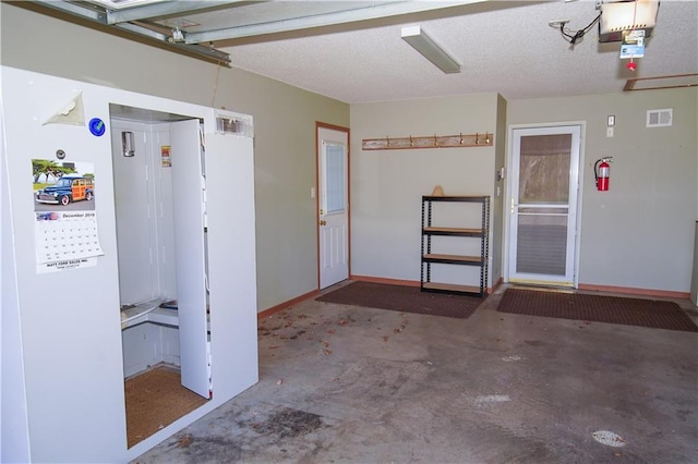 garage with baseboards and visible vents