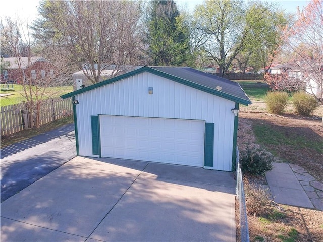 detached garage featuring fence