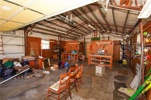 garage featuring a garage door opener and a workshop area