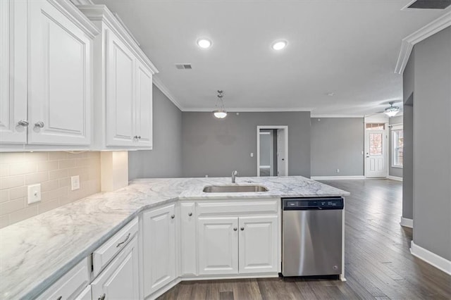 kitchen with dishwasher, a sink, ornamental molding, a peninsula, and baseboards