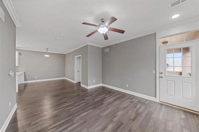 unfurnished room featuring a ceiling fan, dark wood finished floors, baseboards, and crown molding