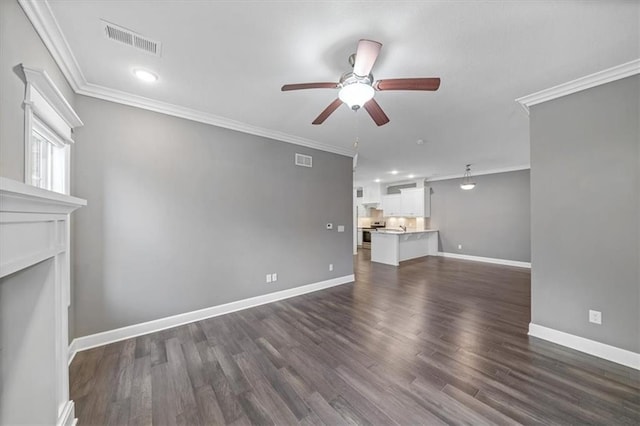 unfurnished living room with ceiling fan, ornamental molding, dark wood finished floors, baseboards, and a fireplace