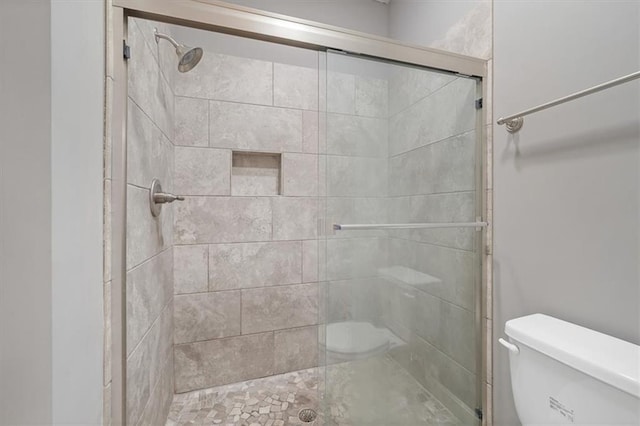 full bathroom with toilet and a shower stall