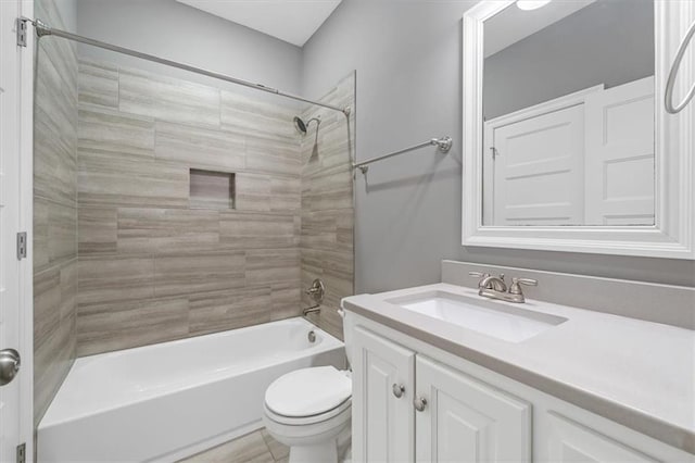 bathroom featuring shower / washtub combination, toilet, and vanity