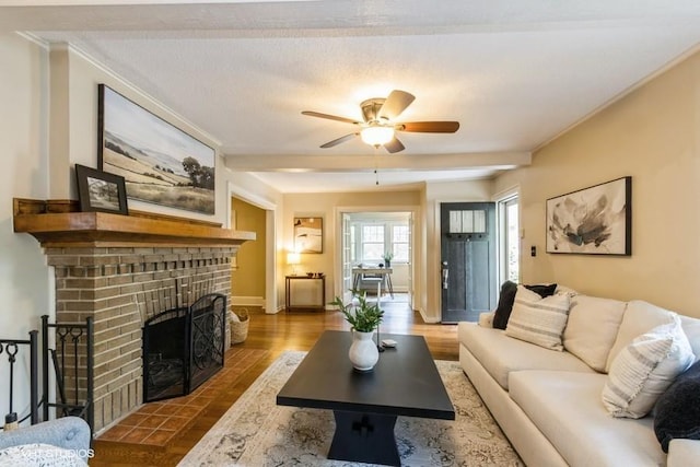 5825 Rockhill Rd, Kansas City, MO 64110 - living area with a fireplace, ceiling fan, baseboards, wood finished floors, and crown molding