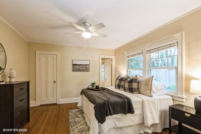 5825 Rockhill Rd, Kansas City, MO 64110 - bedroom with dark wood-style floors, ornamental molding, baseboards, and a ceiling fan