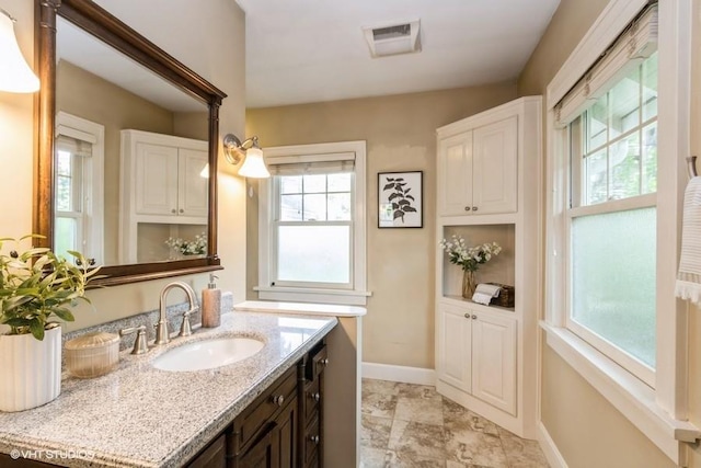 5825 Rockhill Rd, Kansas City, MO 64110 - bathroom with baseboards and vanity