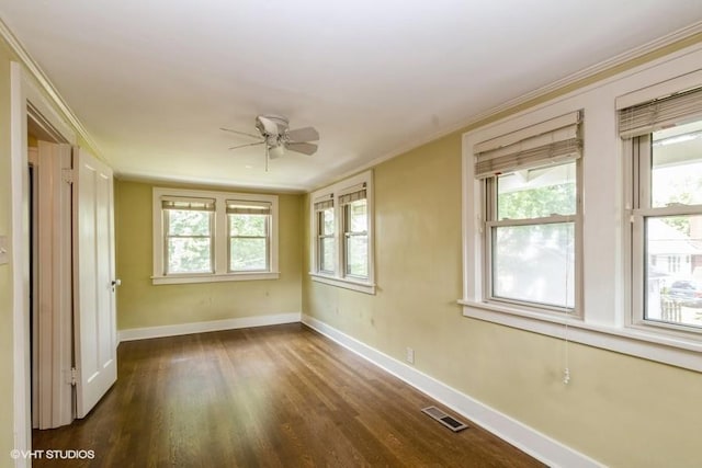 5825 Rockhill Rd, Kansas City, MO 64110 - empty room with wood finished floors, baseboards, ceiling fan, and plenty of natural light