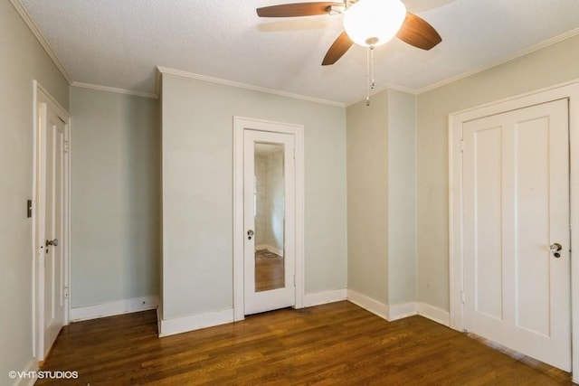5825 Rockhill Rd, Kansas City, MO 64110 - unfurnished bedroom with dark wood finished floors, crown molding, baseboards, and a ceiling fan