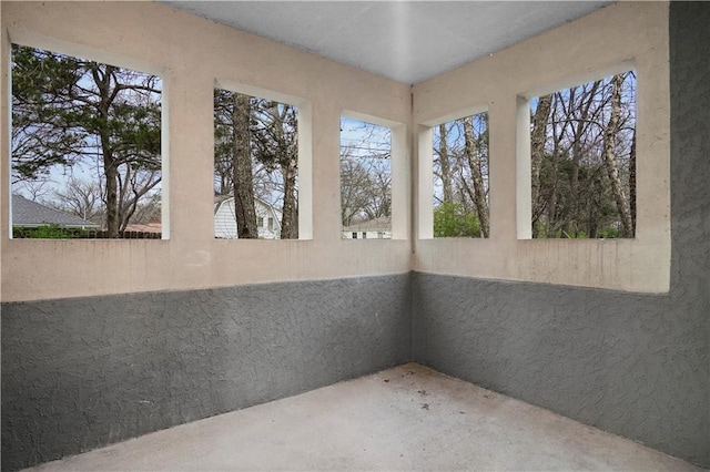 unfurnished sunroom featuring a textured wall
