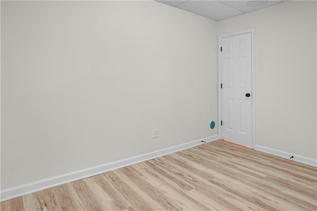 spare room with light wood finished floors and baseboards