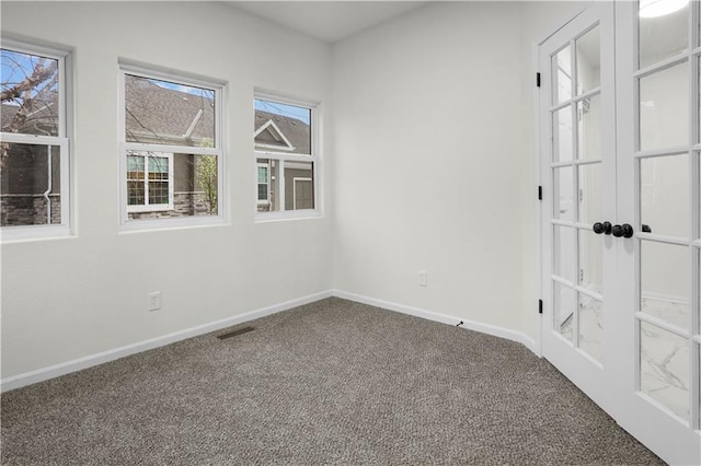 unfurnished room featuring visible vents, french doors, baseboards, and carpet floors