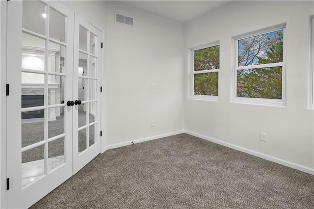 spare room with baseboards, french doors, visible vents, and carpet flooring