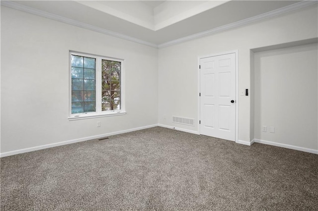 carpeted empty room featuring visible vents, crown molding, and baseboards