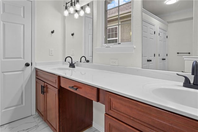 bathroom featuring marble finish floor, a sink, double vanity, and crown molding