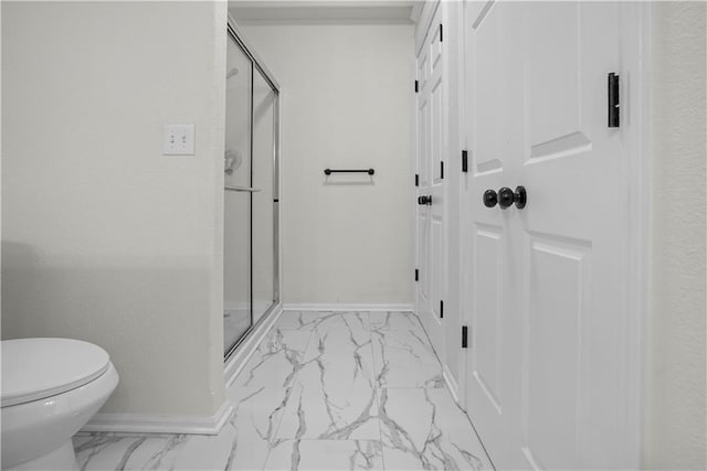 bathroom with marble finish floor, baseboards, toilet, and a stall shower
