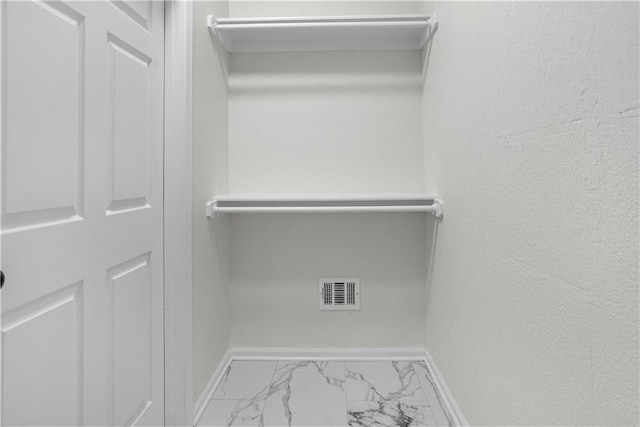 spacious closet with visible vents and marble finish floor