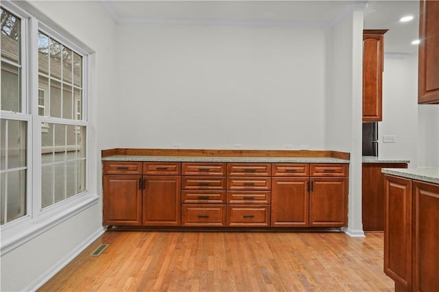 kitchen with light wood-style flooring, visible vents, recessed lighting, and ornamental molding