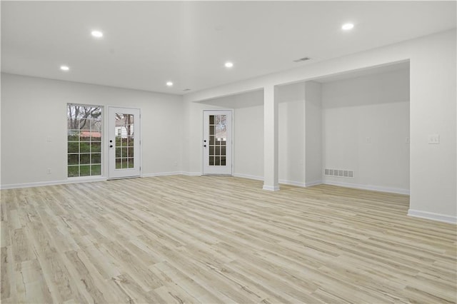 interior space featuring baseboards, recessed lighting, visible vents, and light wood-type flooring