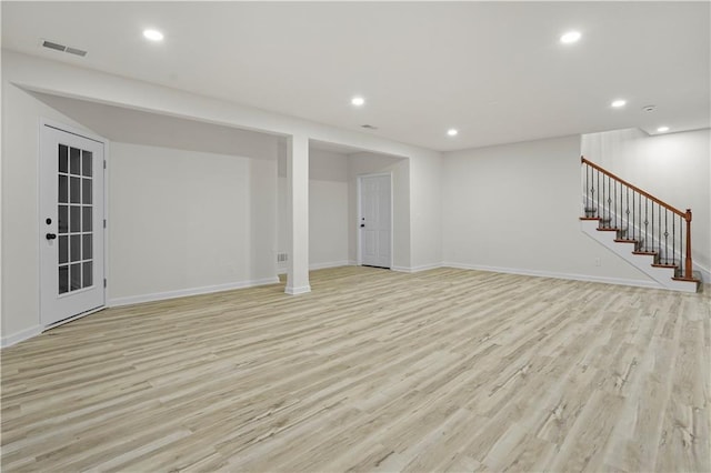 basement with recessed lighting, light wood-type flooring, and visible vents