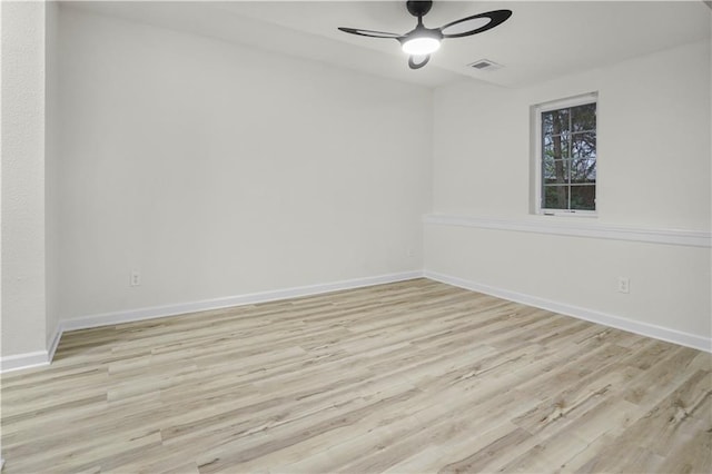 unfurnished room with wood finished floors, visible vents, baseboards, and ceiling fan