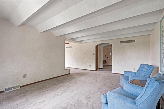 19864 211th St, Tonganoxie, KS 66086 - unfurnished room featuring arched walkways, carpet flooring, baseboards, a textured wall, and beam ceiling