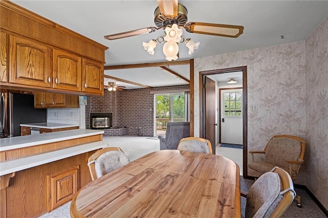 19864 211th St, Tonganoxie, KS 66086 - dining room with ceiling fan, light colored carpet, and a brick fireplace