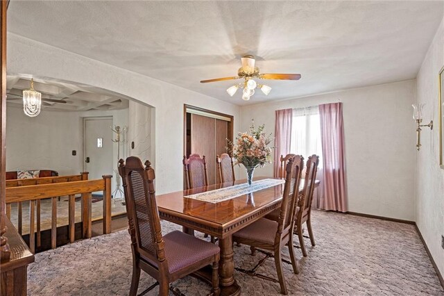 19864 211th St, Tonganoxie, KS 66086 - dining area with a ceiling fan, arched walkways, light colored carpet, and baseboards