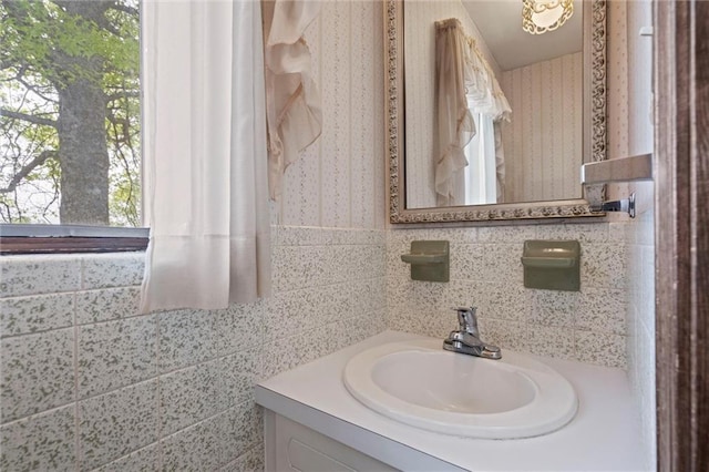 19864 211th St, Tonganoxie, KS 66086 - bathroom with vanity, wallpapered walls, and tile walls