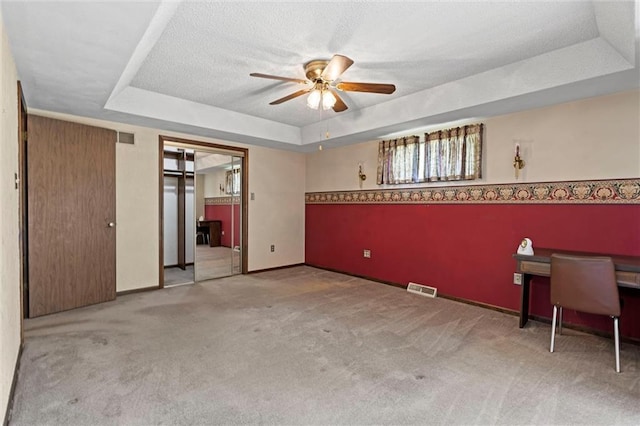 19864 211th St, Tonganoxie, KS 66086 - unfurnished bedroom with a raised ceiling, carpet flooring, a textured ceiling, a ceiling fan, and baseboards