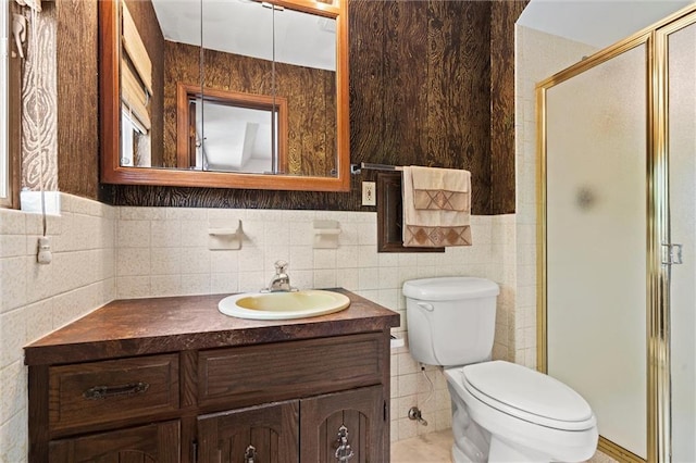 19864 211th St, Tonganoxie, KS 66086 - bathroom featuring a stall shower, vanity, toilet, and tile walls
