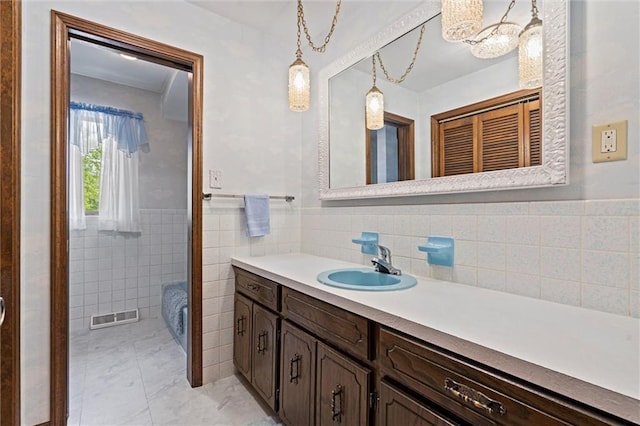 19864 211th St, Tonganoxie, KS 66086 - bathroom featuring tile walls, vanity, a wainscoted wall, and a chandelier
