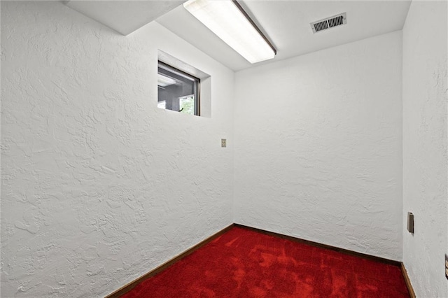 19864 211th St, Tonganoxie, KS 66086 - unfurnished room with dark carpet, a textured wall, and baseboards