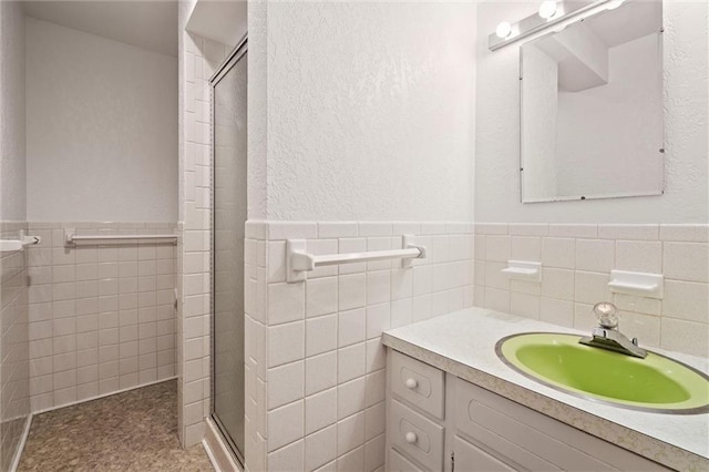 19864 211th St, Tonganoxie, KS 66086 - full bathroom featuring tile walls, a stall shower, vanity, and a wainscoted wall